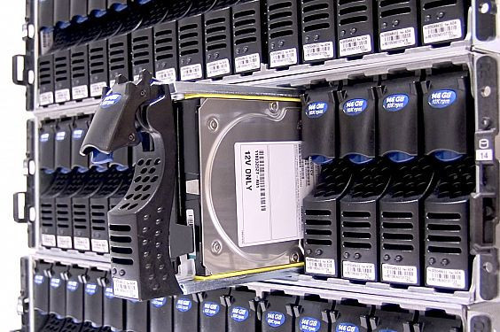 Photograph of a hard drive in a data centre rack pulled out.